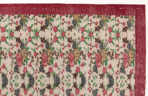 Load image 1 in gallery view. Beige rug with a red border and a repeating floral pattern in red, green, and charcoal.
