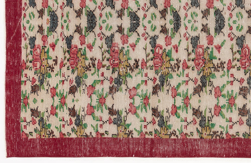 Load image 1 in gallery view. Beige rug with a red border and a repeating floral pattern in red, green, and charcoal on a white background.