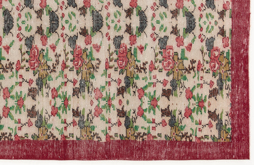 Load image 1 in gallery view. Beige rug with a distressed floral pattern in red, green, and charcoal, featuring a solid red border.