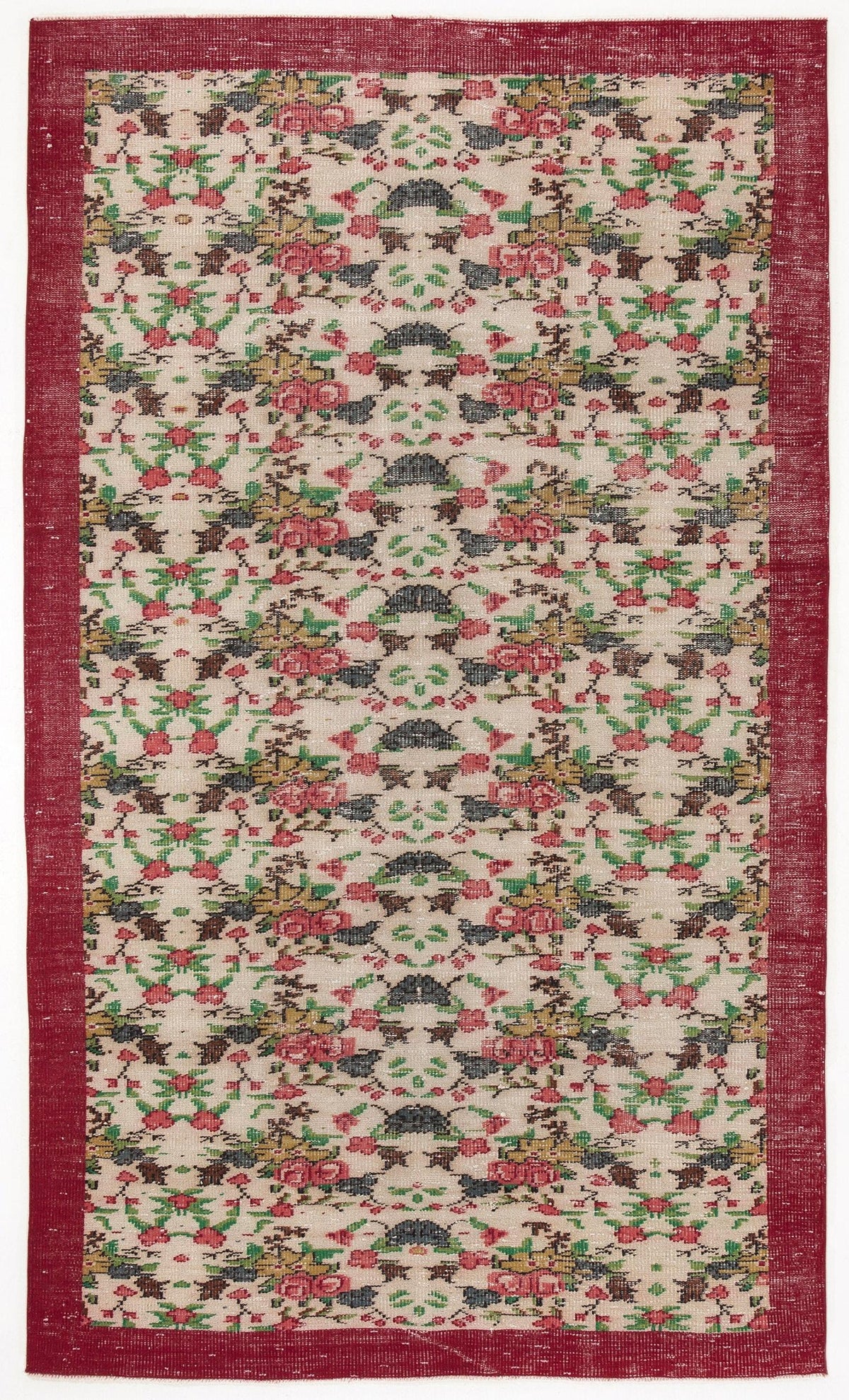 Cream rug with a repeating floral pattern in red, green, and black, featuring a wide solid red border.