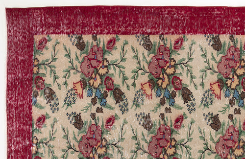 Load image 1 in gallery view. Beige rug with a red border and a repeating floral pattern in red, green, blue, and yellow.