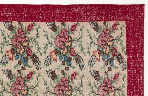 Load image 1 in gallery view. Beige rug with a repeating floral pattern in red, green, and blue, featuring a wide, distressed red border.