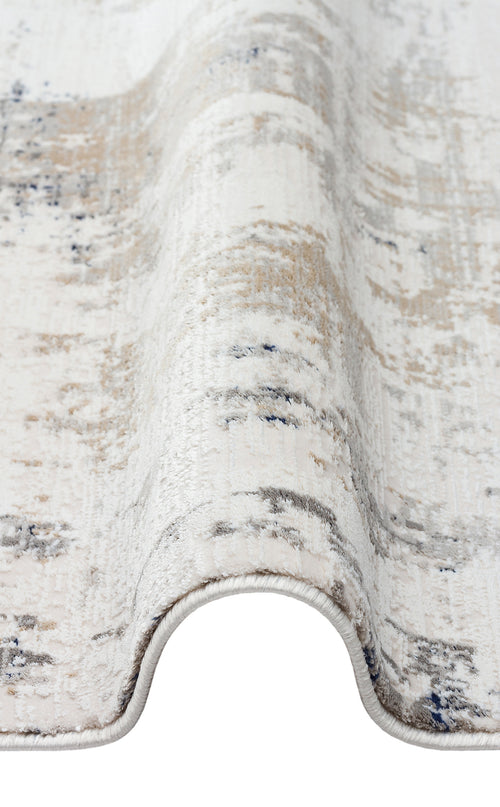 Bild 1 in Galerieansicht laden. Cream, beige, and grey rug with a distressed abstract pattern, shown folded on a white background.