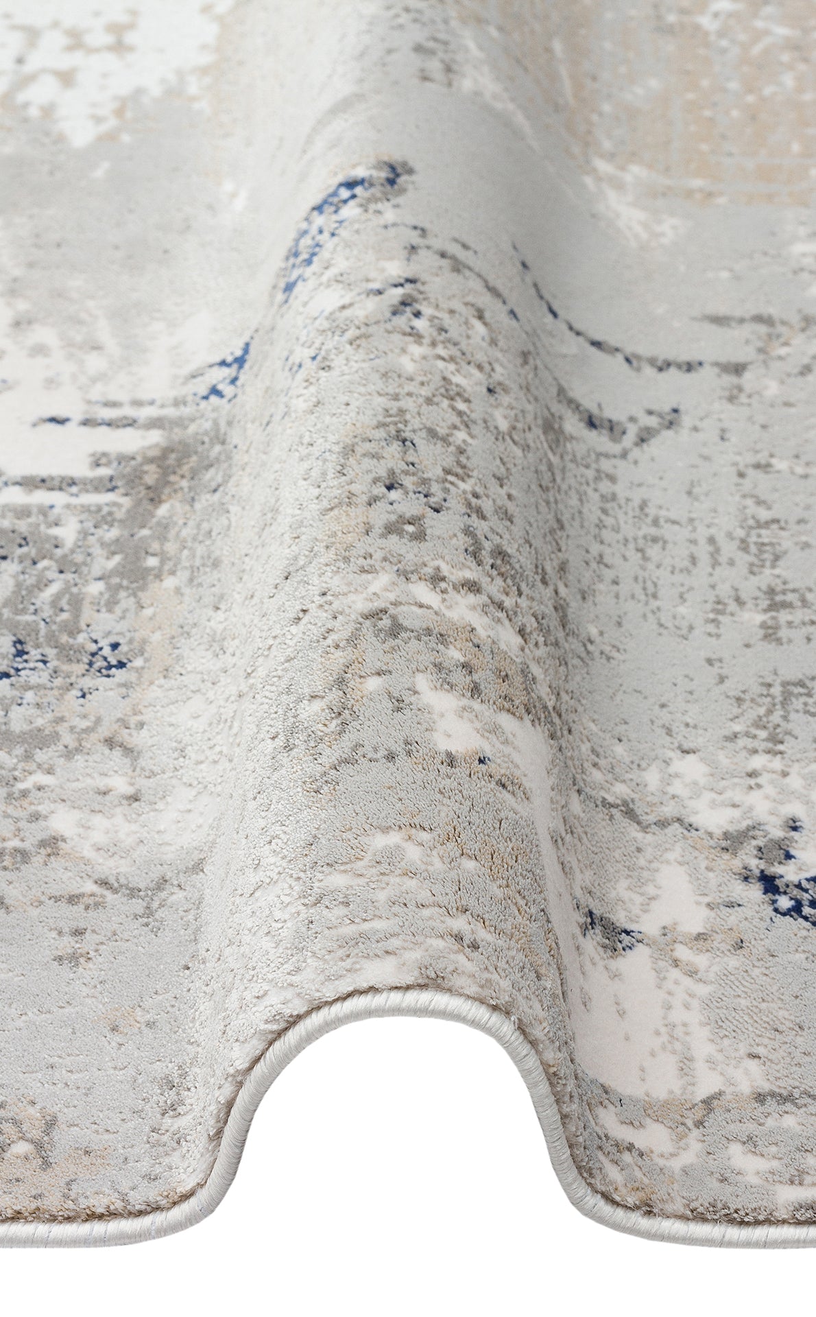 Grey, white, and blue abstract distressed rug with a folded edge on a white background.