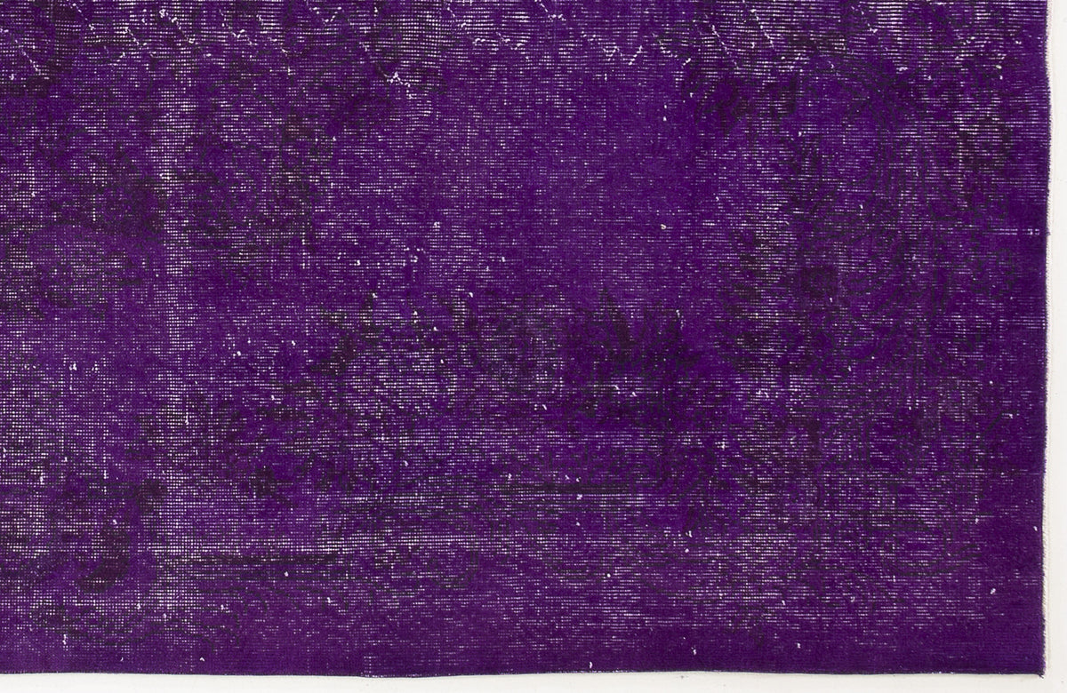 Deep purple vintage-style rug with a distressed, faded traditional floral pattern.