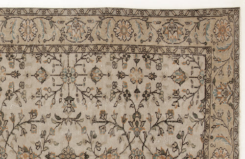 Load image 1 in gallery view. Beige traditional rug with a distressed floral vine pattern in muted blue, orange, and charcoal accents.