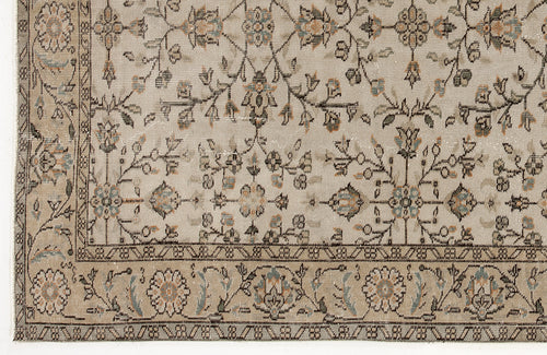 Load image 1 in gallery view. Beige traditional rug with a distressed floral vine pattern in muted blue, orange, and charcoal accents.