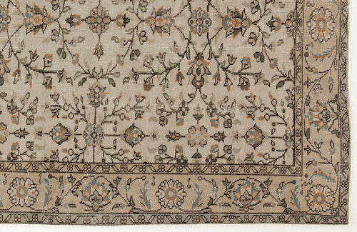 Load image 1 in gallery view. Beige rug with a traditional floral vine pattern in muted blue, orange, and charcoal, featuring a detailed border.