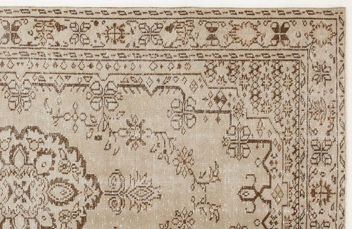 Load image 1 in gallery view. Beige and brown traditional rug with a distressed floral medallion pattern and ornate geometric border.