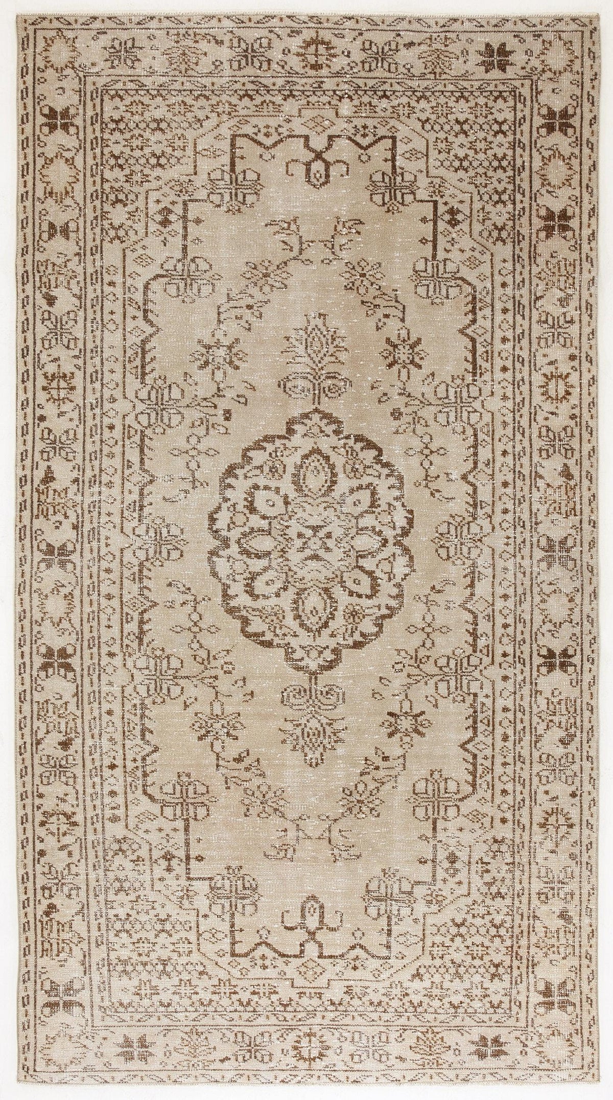 Beige and brown vintage-style rug with a central floral medallion and intricate geometric border pattern.