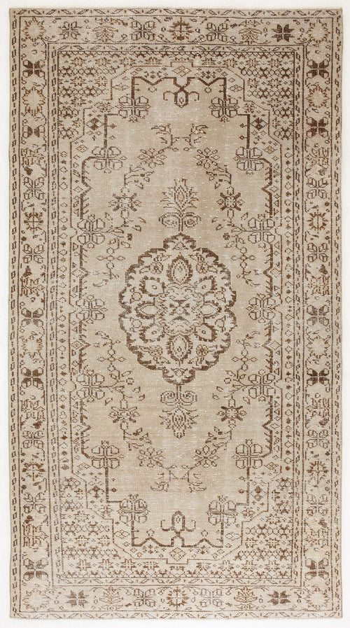 Load image 1 in gallery view. Beige and brown vintage-style rug with a central floral medallion and intricate geometric border pattern.