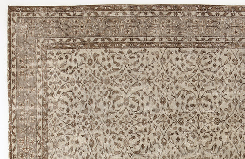 Load image 1 in gallery view. Taupe and brown vintage-style rug with a distressed floral trellis pattern and a decorative border.