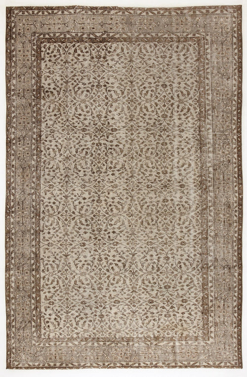 Load image 1 in gallery view. Taupe and brown distressed vintage-style rug with a repeating floral medallion pattern and a wide decorative border.