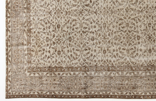 Load image 1 in gallery view. Beige and brown distressed rug with a traditional floral medallion pattern and a detailed border.