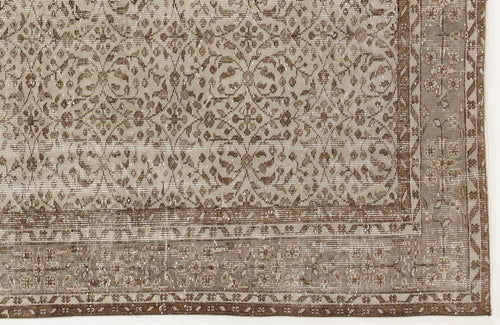 Load image 1 in gallery view. Taupe and brown distressed rug with a traditional floral medallion pattern and a decorative border.