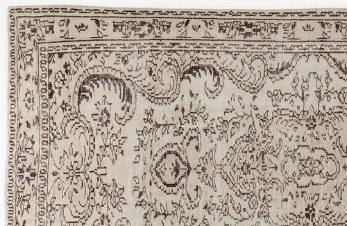 Load image 1 in gallery view. Beige rug with a dark brown distressed traditional floral pattern and a geometric border.