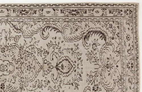 Load image 1 in gallery view. Beige rug with a dark brown traditional floral medallion pattern and a geometric border.