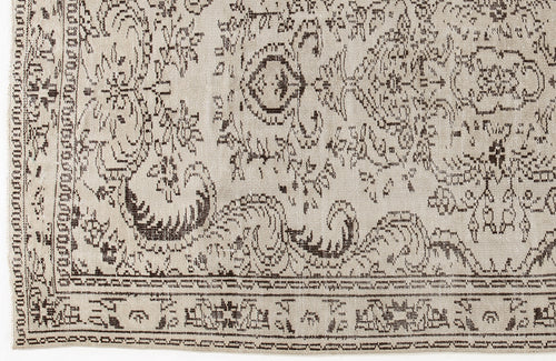 Load image 1 in gallery view. Beige rug with a dark brown distressed floral medallion pattern and a geometric border.