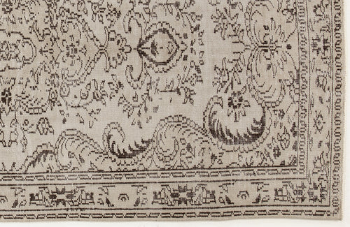Load image 1 in gallery view. Beige rug with a dark brown traditional floral medallion pattern and a detailed geometric border.