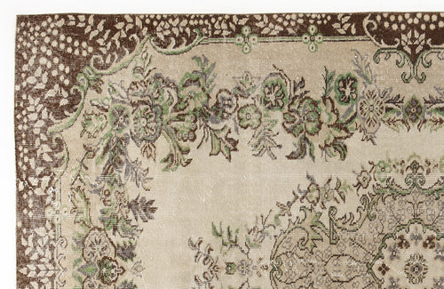 Load image 1 in gallery view. Beige rug with a dark brown border and green and grey floral medallion pattern.