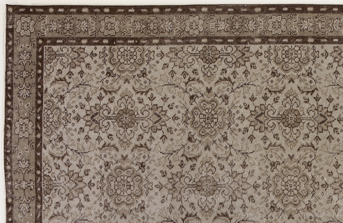 Taupe and dark brown traditional rug with a dense floral medallion pattern and a geometric border.