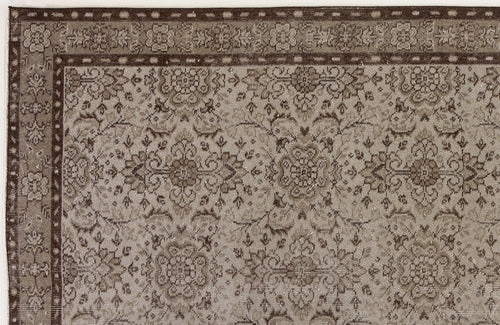 Load image 1 in gallery view. Taupe and dark brown traditional rug with a dense floral medallion pattern and a geometric border.