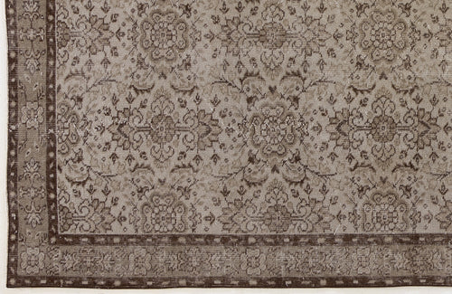 Load image 1 in gallery view. Taupe and dark brown rug with a distressed traditional floral medallion pattern and a decorative border.