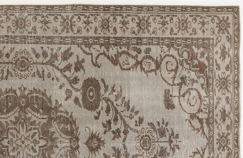 Load image 1 in gallery view. Taupe and brown rug with a distressed traditional floral medallion pattern and a decorative border.