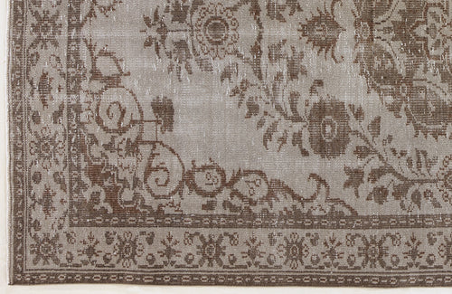 Load image 1 in gallery view. Taupe and brown distressed rug with a traditional floral medallion pattern and a detailed geometric border.