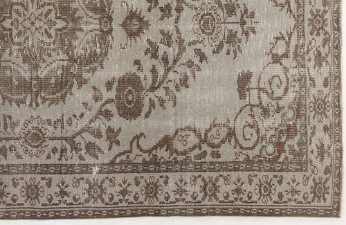 Load image 1 in gallery view. Taupe and brown distressed rug with a traditional floral medallion pattern and a decorative border.
