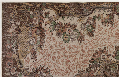Load image 1 in gallery view. Brown, beige, and sage green traditional rug with a distressed floral and vine pattern.