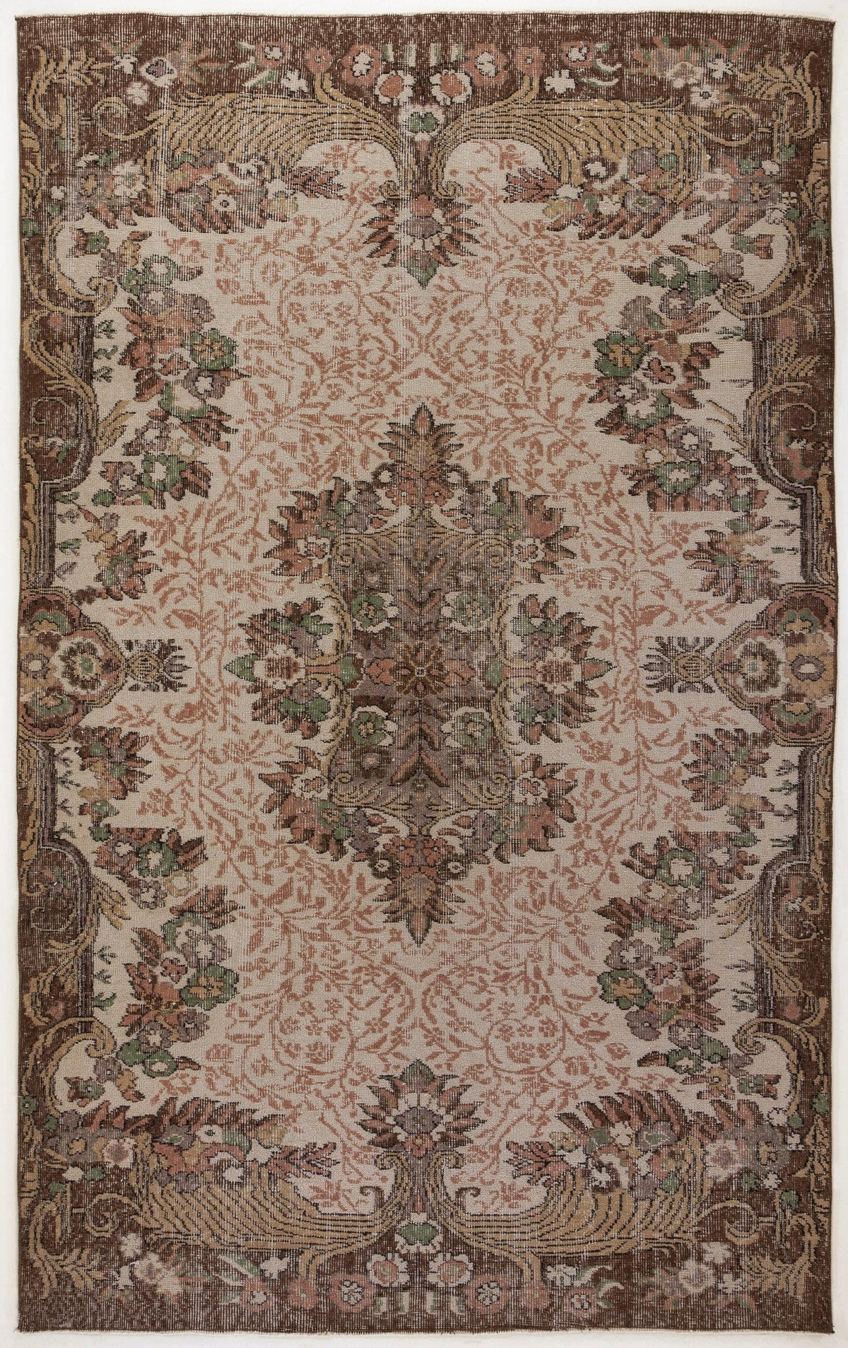 Brown and beige traditional rug with a central floral medallion and ornate border in muted green, pink, and brown tones.