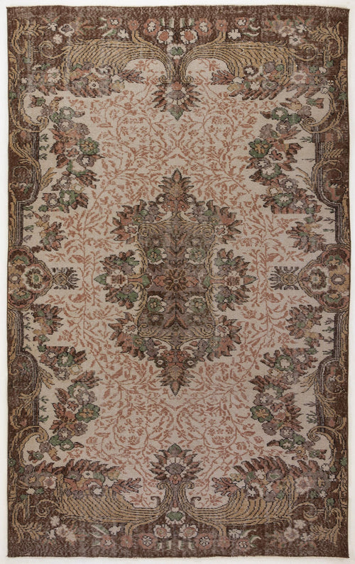 Load image 1 in gallery view. Brown and beige traditional rug with a central floral medallion and ornate border in muted green, pink, and brown tones.