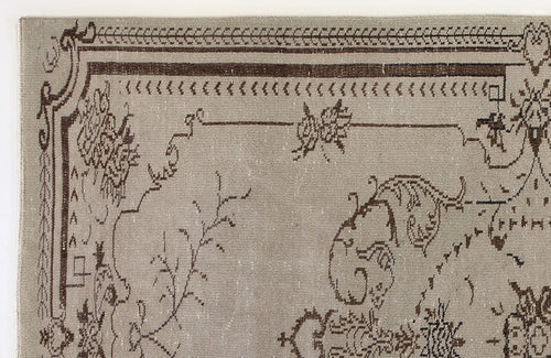 Load image 1 in gallery view. Taupe rug with a dark brown traditional border and intricate floral line-work pattern on a white background.