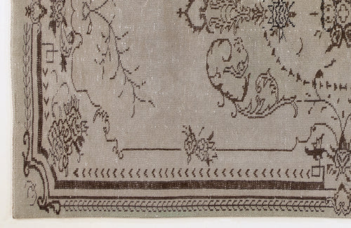 Load image 1 in gallery view. Taupe rug with a distressed dark brown traditional floral border and central medallion pattern.