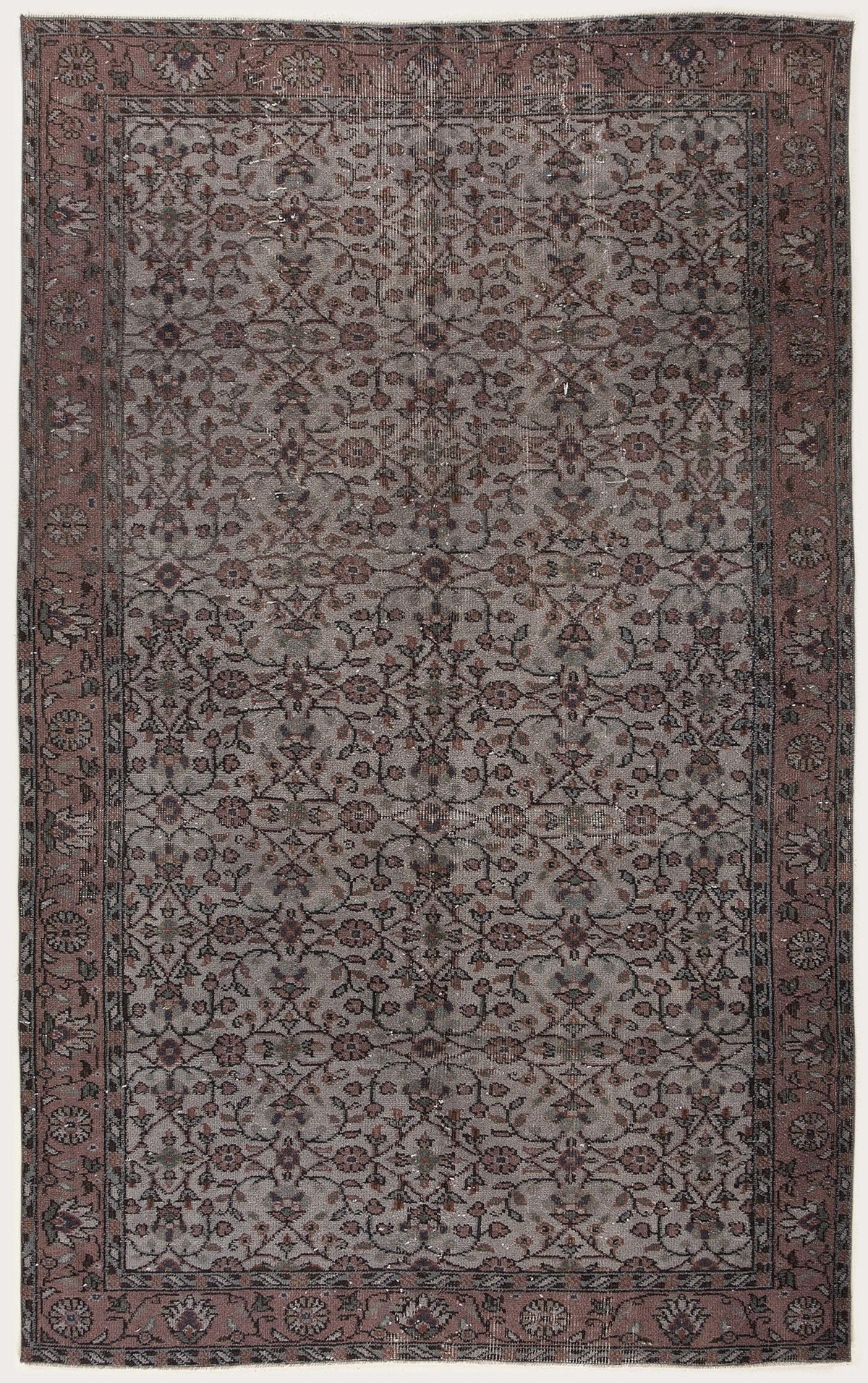 Muted grey and dusty rose traditional rug with an all-over floral vine pattern and a wide decorative border.