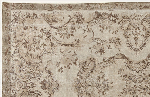 Load image 1 in gallery view. Beige and brown distressed rug with a traditional floral medallion pattern and a geometric border.