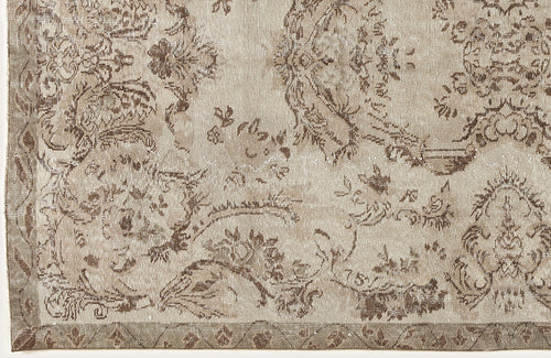 Load image 1 in gallery view. Beige and taupe vintage-style rug with a distressed floral medallion pattern and a geometric border.