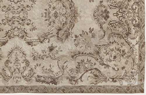 Load image 1 in gallery view. Taupe and brown distressed rug with a traditional floral medallion pattern and a geometric border.