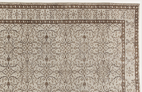 Load image 1 in gallery view. Beige and brown traditional rug with a repeating floral medallion pattern and a detailed geometric border.