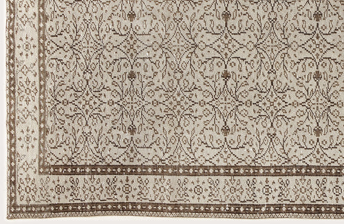 Load image 1 in gallery view. Beige and brown rug with a repeating floral medallion pattern and a decorative geometric border.