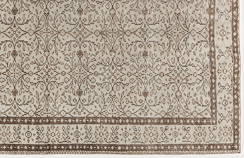 Load image 1 in gallery view. Beige and brown vintage-style rug with a repeating floral medallion pattern and a detailed geometric border.