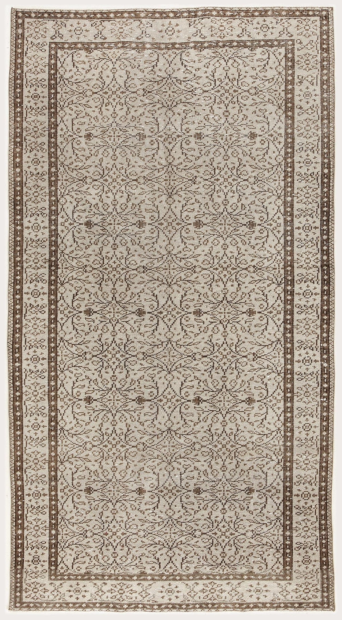 Beige and brown vintage-style rug with a repeating floral medallion pattern and a decorative geometric border.