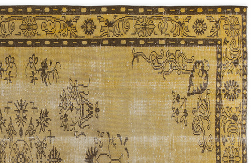 Load image 1 in gallery view. Mustard yellow and dark brown distressed rug with a traditional floral border and scattered botanical motifs.