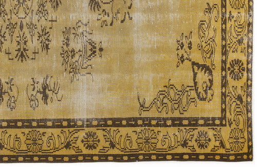 Load image 1 in gallery view. Distressed mustard yellow and dark brown rug with a traditional floral medallion border and faded central motifs.