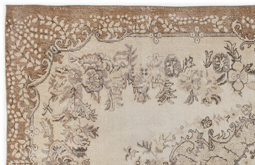 Load image 1 in gallery view. Tan and cream vintage-style rug with a distressed floral medallion pattern and ornate border.