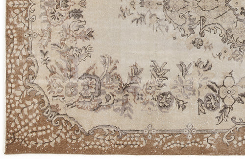 Load image 1 in gallery view. Beige and brown vintage-style rug with a distressed floral medallion pattern and a decorative border.