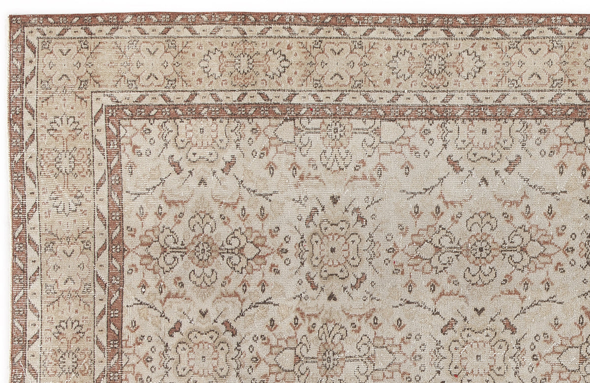 Beige and terracotta traditional rug with a distressed floral medallion pattern and a geometric border.