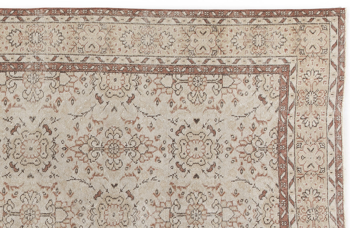 Beige and terracotta traditional rug with a distressed floral medallion pattern and geometric border.