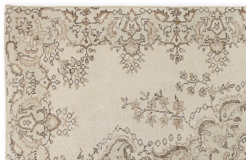 Load image 1 in gallery view. Beige rug with a distressed brown floral and vine pattern on a white background.